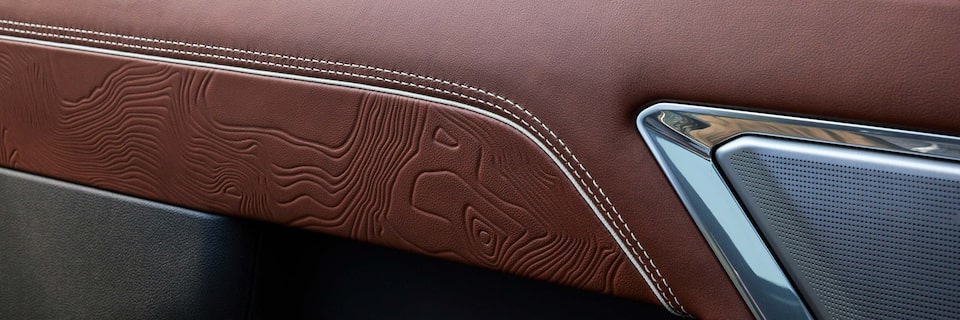 Official 2024 GMC Denali anniversary photography showing the Denali Ultimate interior badge; not the original 1999 badge