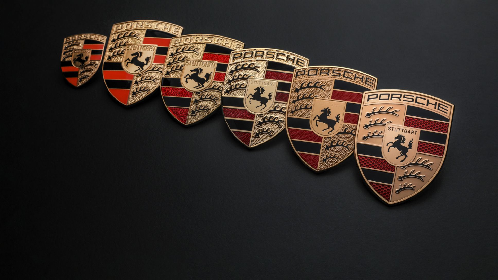 Porsche’s official comparison of historical crests and the 2023 update